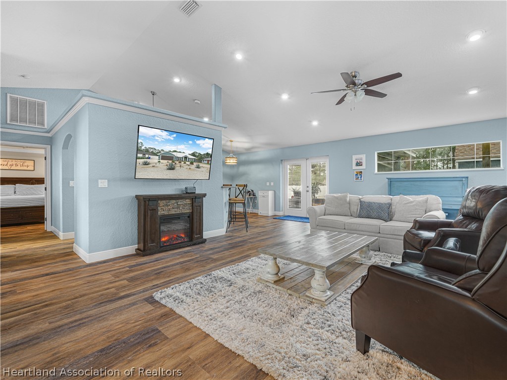 5430 Lakewood Road Sebring, FL 33875 - Photo 7 of 40 a living room with furniture and a fireplace