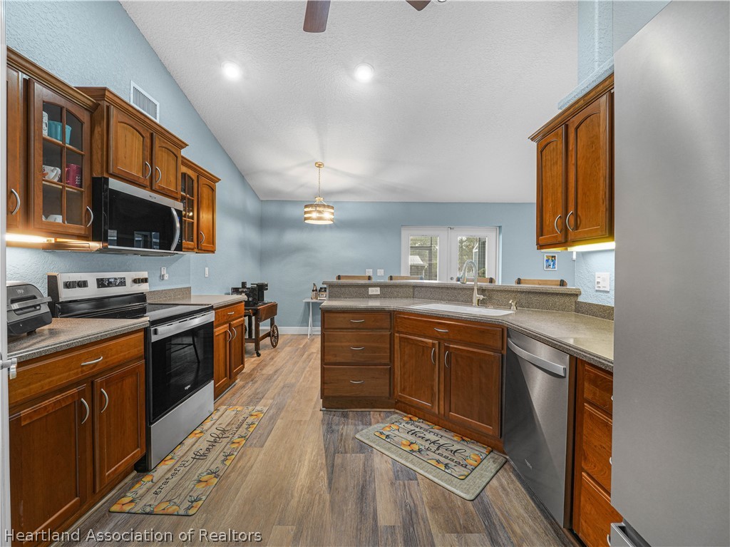 5430 Lakewood Road Sebring, FL 33875 - Photo 9 of 40 a large kitchen with stainless steel appliances granite countertop a stove and a sink