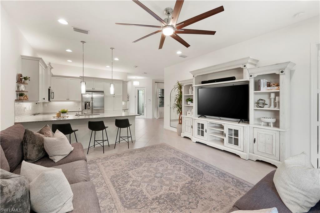 11989 Five Waters Circle Fort Myers, FL 33913 - Photo 13 of 32 a living room with furniture and a flat screen tv