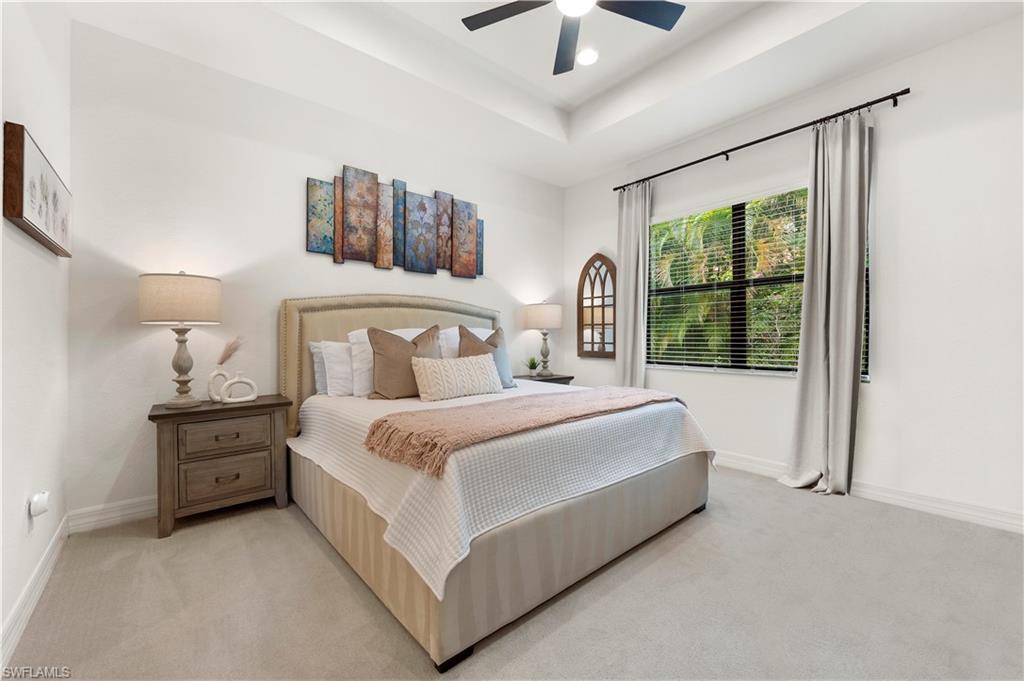 11989 Five Waters Circle Fort Myers, FL 33913 - Photo 15 of 32 a bedroom with a large bed and a chandelier fan
