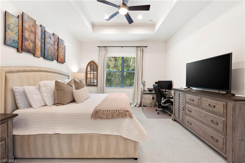 11989 Five Waters Circle Fort Myers, FL 33913 - Photo 16 of 32 a bedroom with a bed and a flat screen tv