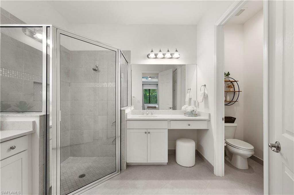 11989 Five Waters Circle Fort Myers, FL 33913 - Photo 17 of 32 a bathroom with a granite countertop sink a toilet and shower