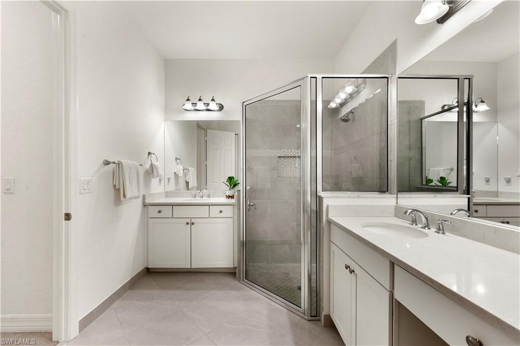 11989 Five Waters Circle Fort Myers, FL 33913 - Photo 18 of 32 a bathroom with a double vanity sink mirror and shower