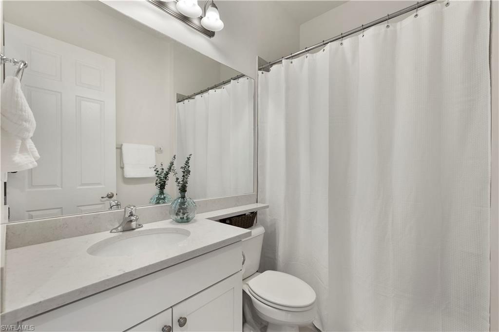11989 Five Waters Circle Fort Myers, FL 33913 - Photo 21 of 32 a bathroom with a granite countertop sink and a mirror