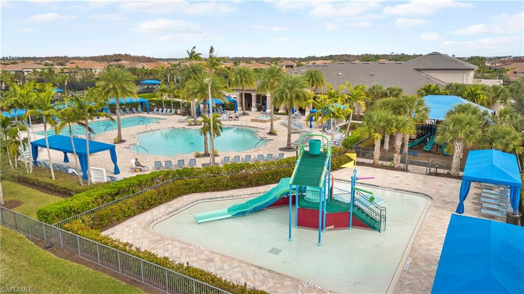 11989 Five Waters Circle Fort Myers, FL 33913 - Photo 27 of 32 a view of a swimming pool with a table and chairs