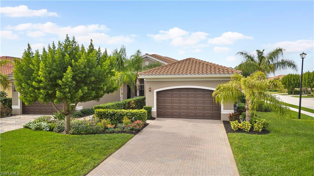 11989 Five Waters Circle Fort Myers, FL 33913 - Photo 30 of 32 a front view of a house with garden