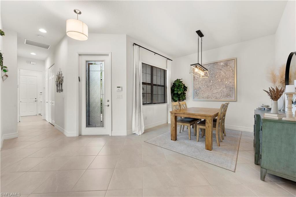11989 Five Waters Circle Fort Myers, FL 33913 - Photo 8 of 32 a view of a livingroom with furniture and a floor to ceiling window