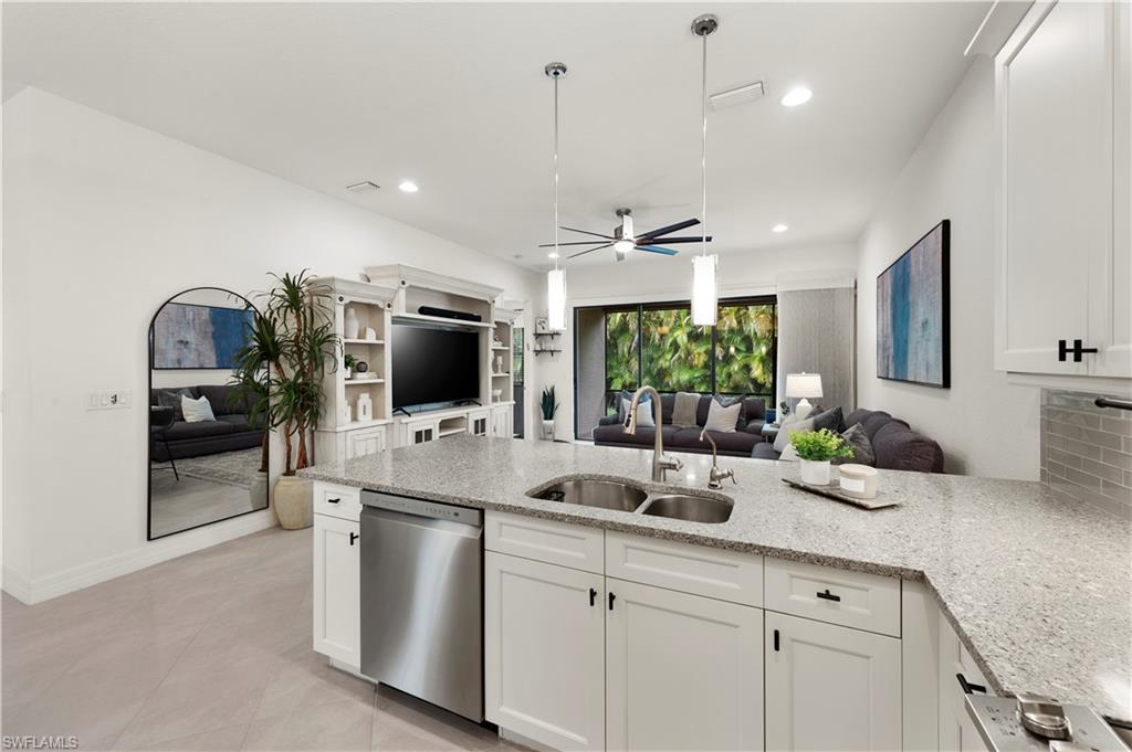 11989 Five Waters Circle Fort Myers, FL 33913 - Photo 10 of 32 a kitchen with counter top oven and sink