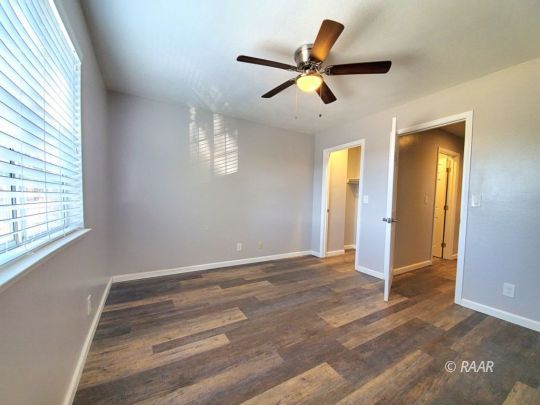 128 South Lilac Street Ridgecrest, CA 93555 - Photo 14 of 24 a view of room with ceiling fan and window