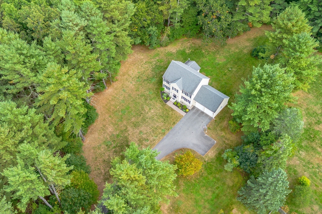 3 Gilson Road Littleton, MA 01460 - Photo 12 of 36 an aerial view of a house with a yard and trees all around