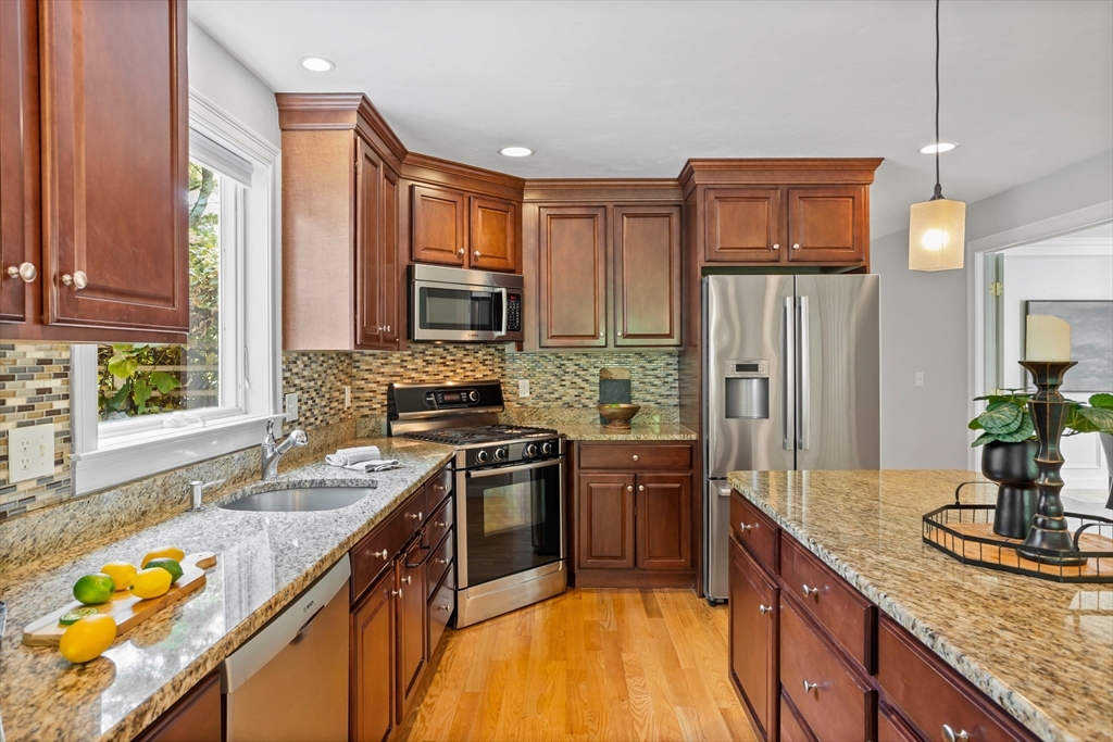 3 Gilson Road Littleton, MA 01460 - Photo 17 of 36 a kitchen with stainless steel appliances granite countertop a sink a stove and a refrigerator