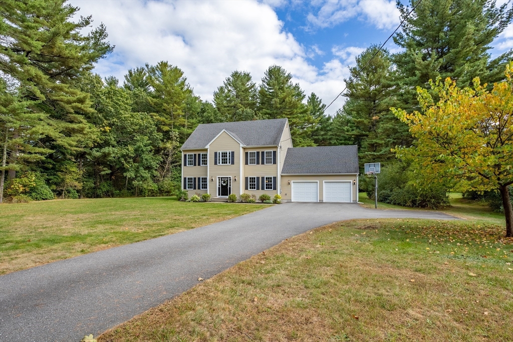 3 Gilson Road Littleton, MA 01460 - Photo 2 of 36 a front view of a house with a yard and trees