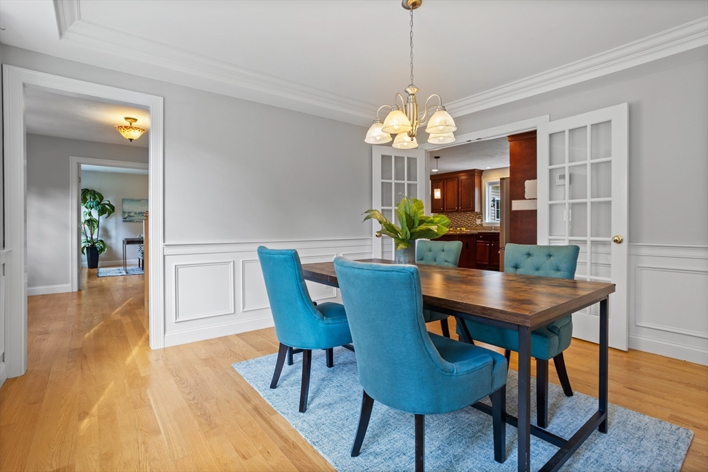 3 Gilson Road Littleton, MA 01460 - Photo 24 of 36 a view of a dining room with furniture a chandelier and wooden floor