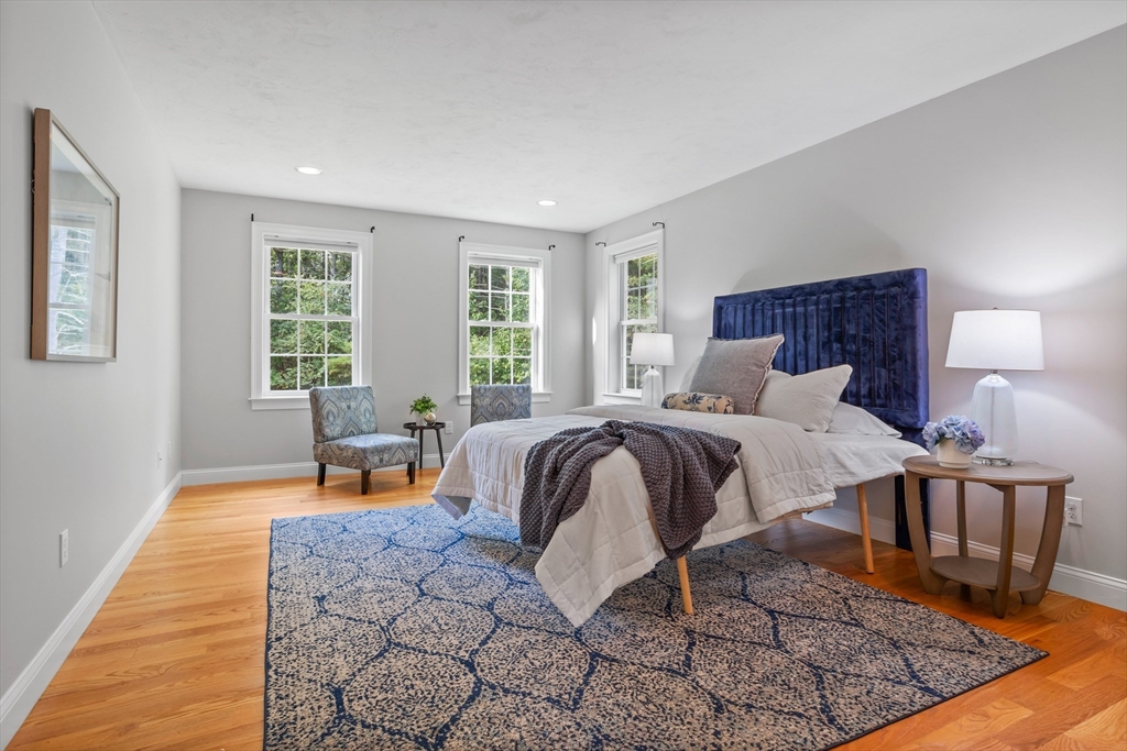 3 Gilson Road Littleton, MA 01460 - Photo 26 of 36 a bedroom with a bed a table and chair with the wooden floor