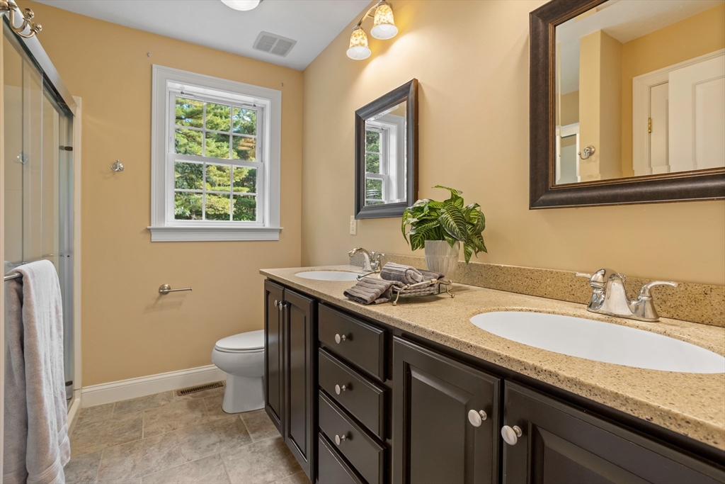 3 Gilson Road Littleton, MA 01460 - Photo 28 of 36 a bathroom with a granite countertop sink and a mirror