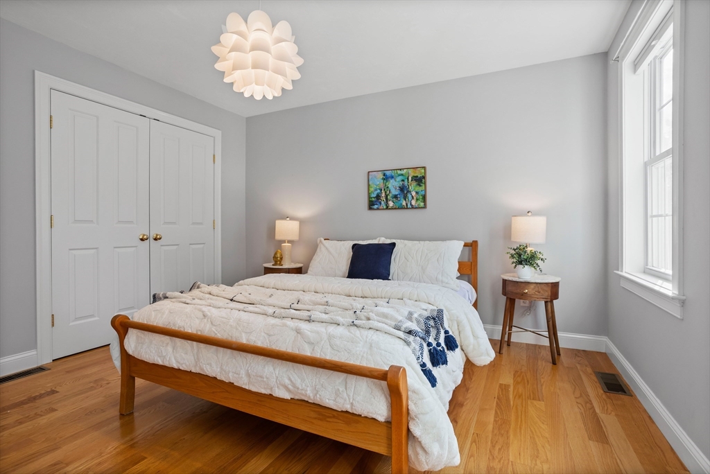 3 Gilson Road Littleton, MA 01460 - Photo 30 of 36 a bedroom with a bed and a chandelier