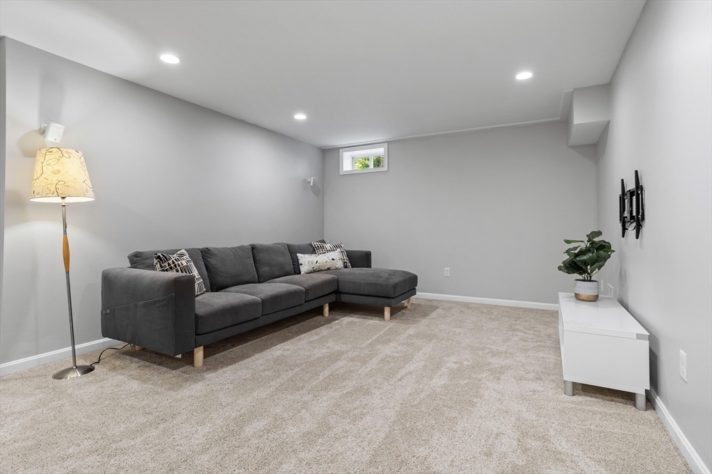 3 Gilson Road Littleton, MA 01460 - Photo 32 of 36 a living room with furniture and a potted plant