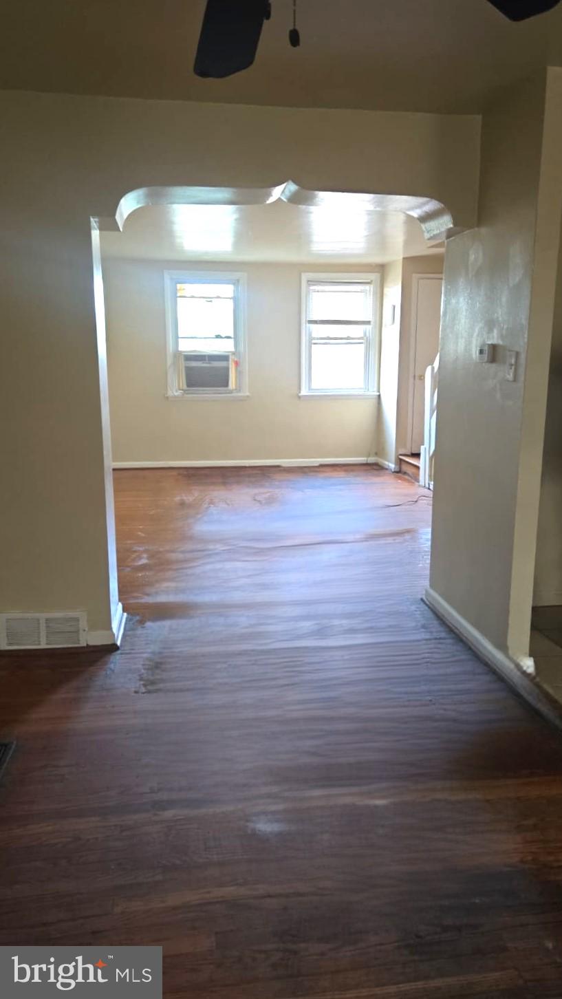 5202 F Street Philadelphia, PA 19124 - Photo 4 of 14 a view of an empty room with wooden floor and a window