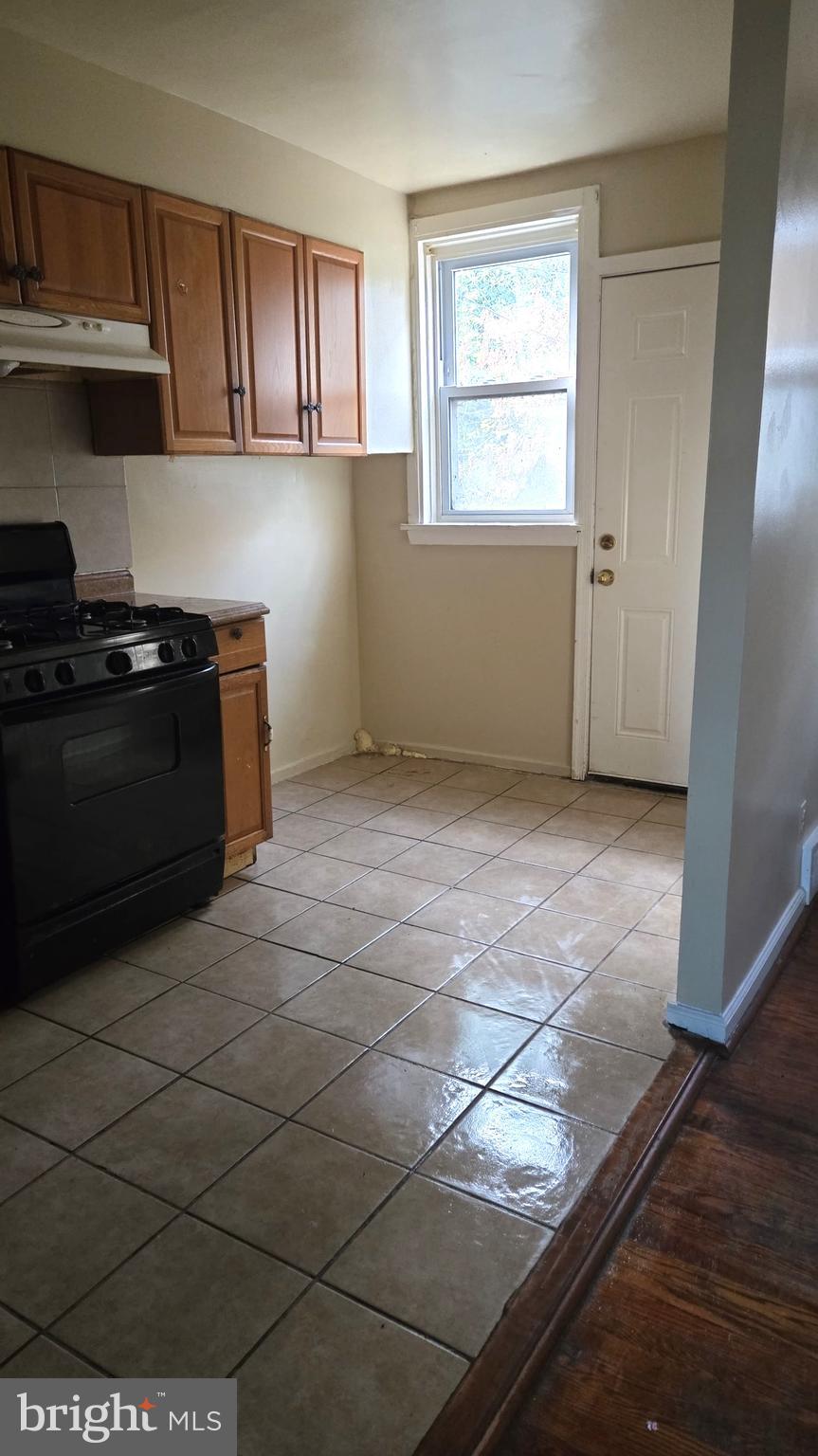 5202 F Street Philadelphia, PA 19124 - Photo 5 of 14 a kitchen with a stove and a cabinet