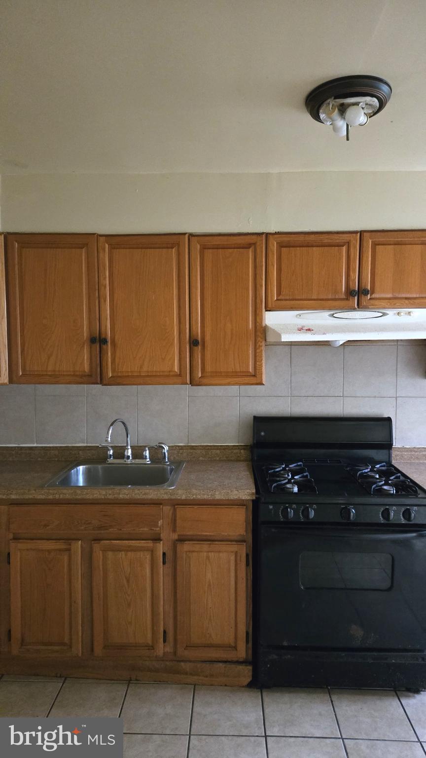 5202 F Street Philadelphia, PA 19124 - Photo 6 of 14 a kitchen with a stove and a cabinet