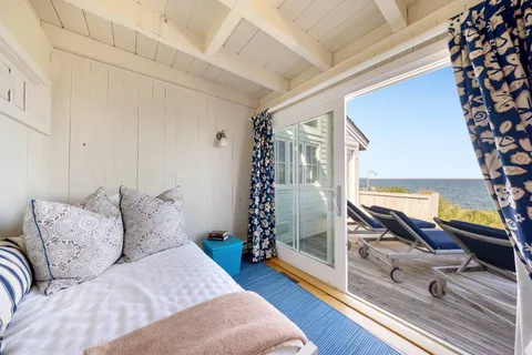 a bedroom with furniture and a large window