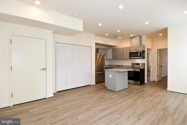 a kitchen with a refrigerator and a stove top oven