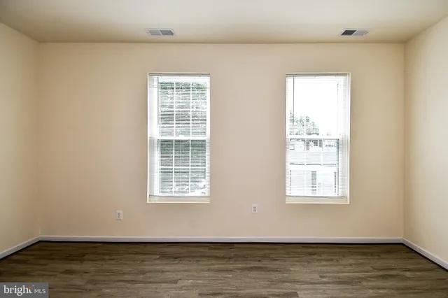 a view of a room with wooden floor and window