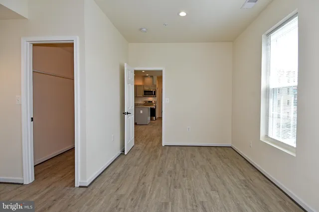 a view of a room with wooden floor and a window