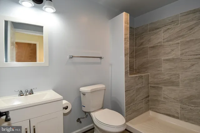 a bathroom with a toilet a sink and shower