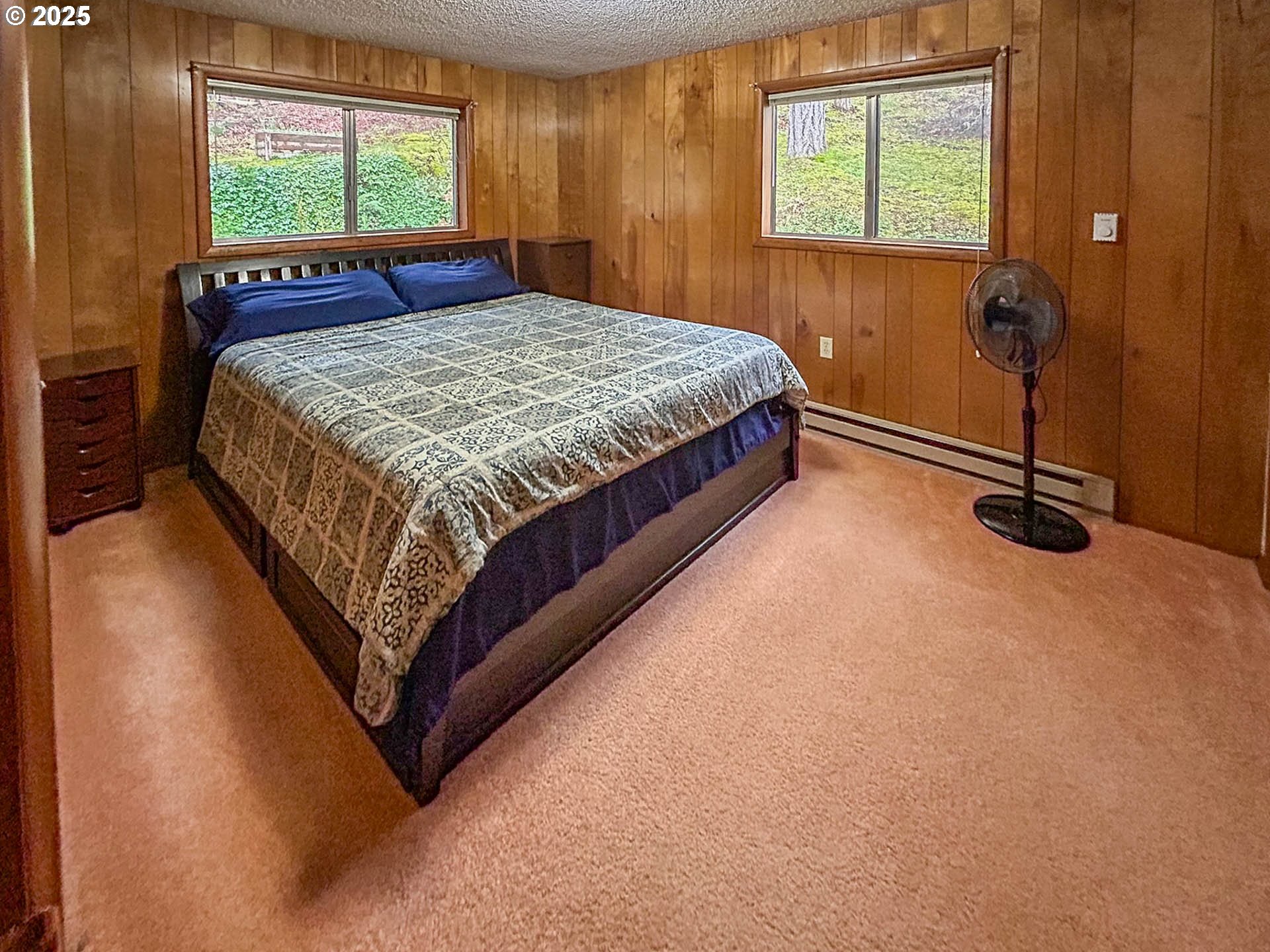1260 Canyonville-Riddle Road Riddle, OR 97469 - Photo 16 of 44 a bed sitting in a bedroom next to a window
