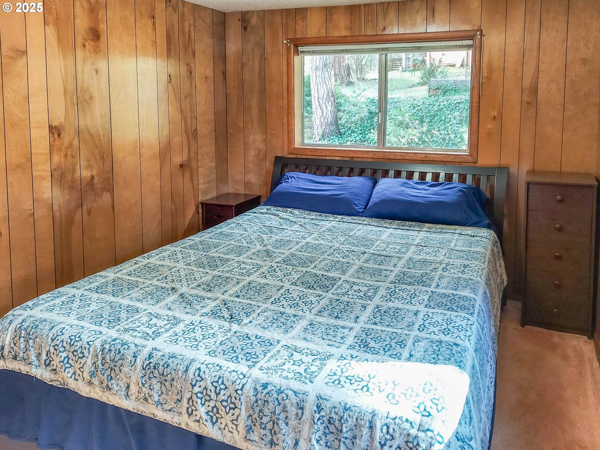 1260 Canyonville-Riddle Road Riddle, OR 97469 - Photo 17 of 44 a bed sitting in a bedroom next to a window