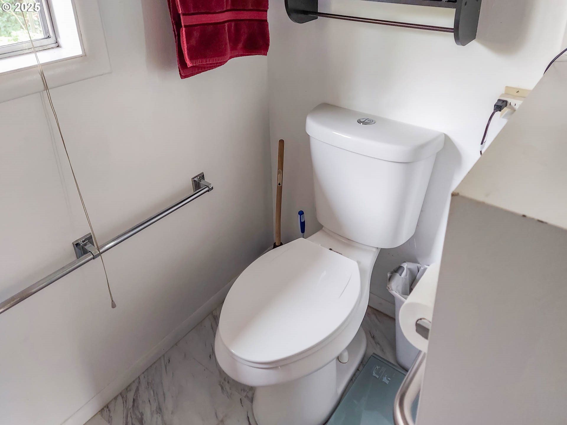 1260 Canyonville-Riddle Road Riddle, OR 97469 - Photo 21 of 44 a white toilet sitting next to a bathroom sink and a window