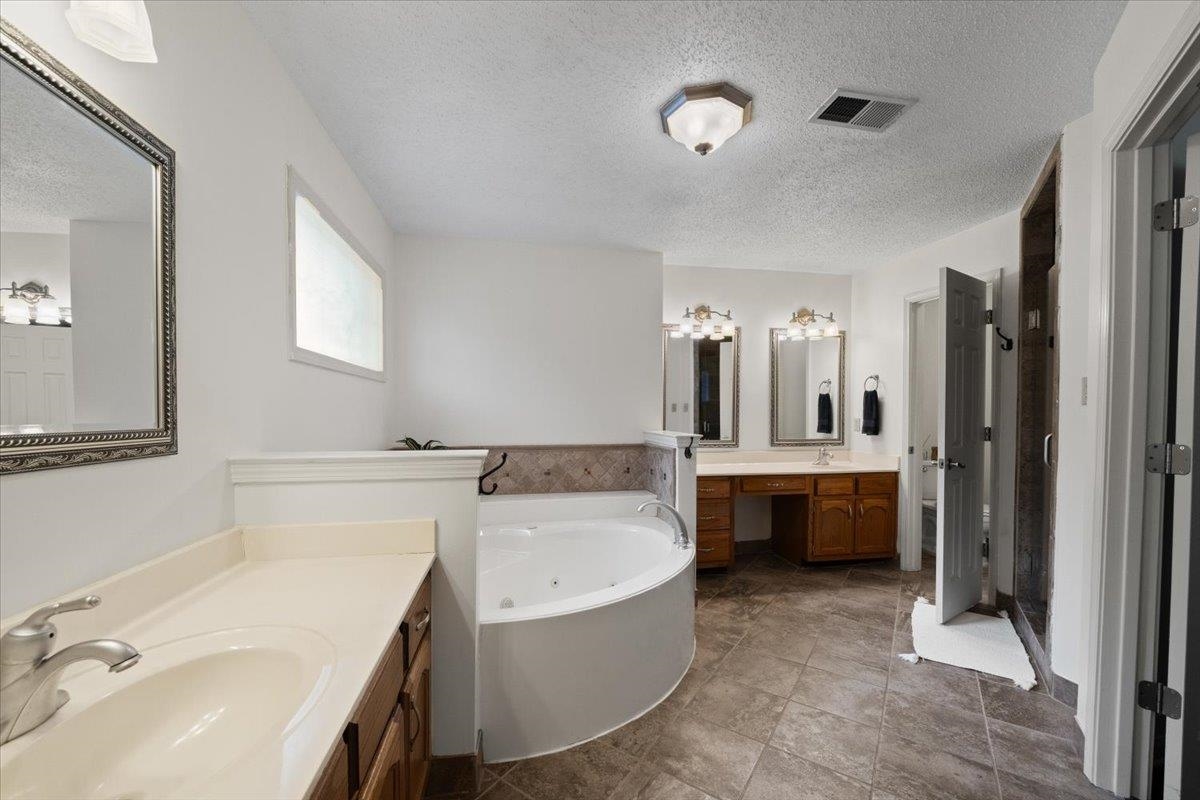 276 Morton Road Collierville, TN 38017 - Photo 14 of 33 a bathroom with a tub sink and mirror