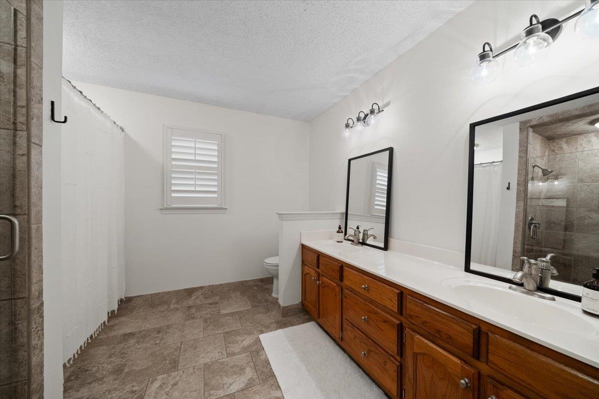 276 Morton Road Collierville, TN 38017 - Photo 17 of 33 a bathroom with a double vanity sink and mirror