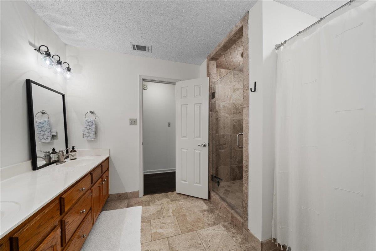 276 Morton Road Collierville, TN 38017 - Photo 18 of 33 a bathroom with a double vanity sink mirror and shower