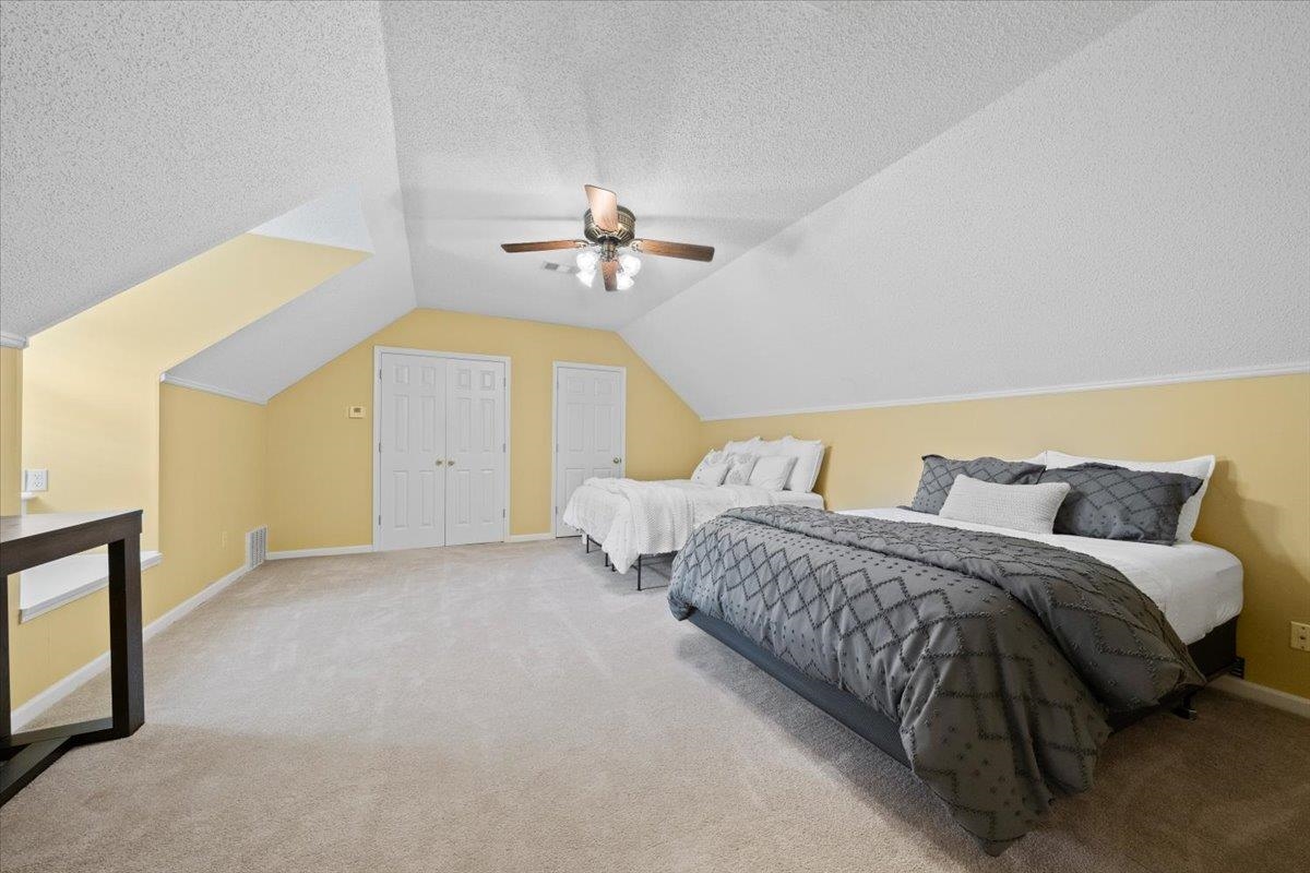 276 Morton Road Collierville, TN 38017 - Photo 20 of 33 a spacious bedroom with two beds and chandelier