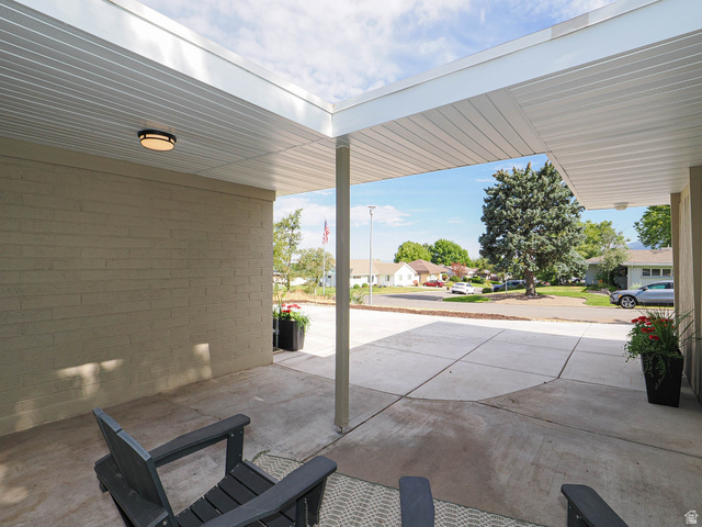 154 East 3000th Street South Bountiful, UT 84010 - Photo 32 of 37 Covered concrete patio featuring a brick exterior wall, recessed lighting, and a paved driveway