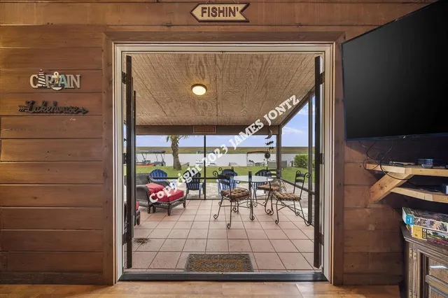 a view of a backyard with potted plants and palm trees