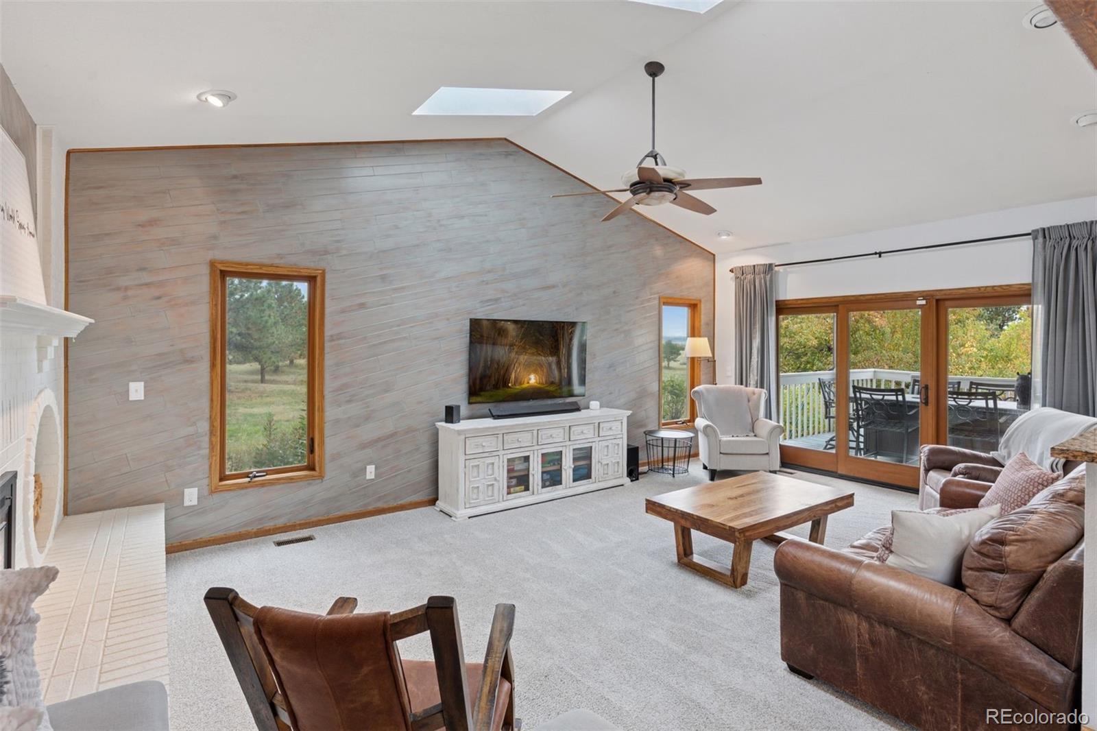 7501 Stroh Road Parker, CO 80134 - Photo 12 of 49 a living room with furniture a flat screen tv and a window