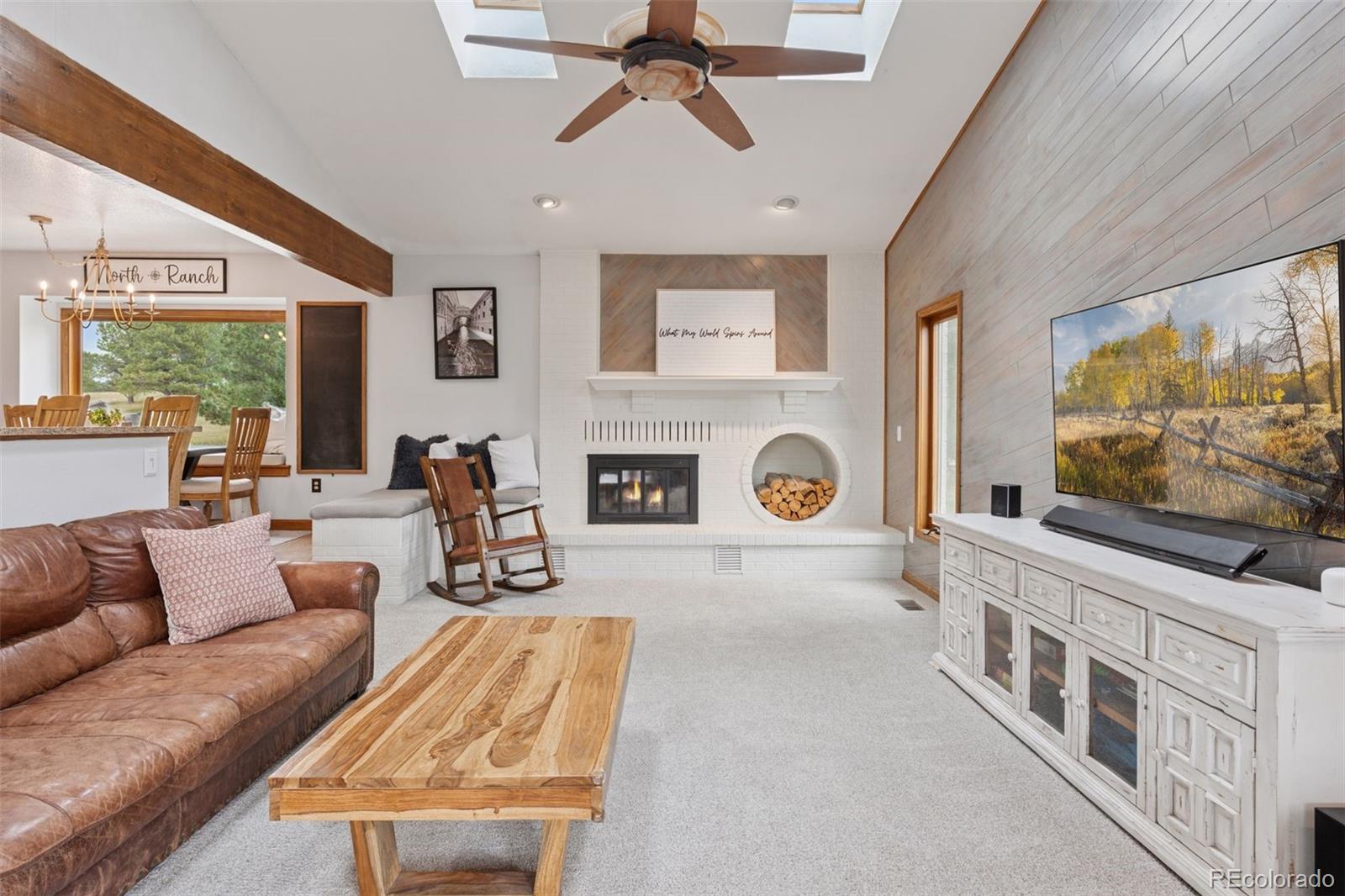 7501 Stroh Road Parker, CO 80134 - Photo 15 of 49 a living room with fireplace furniture and a flat screen tv