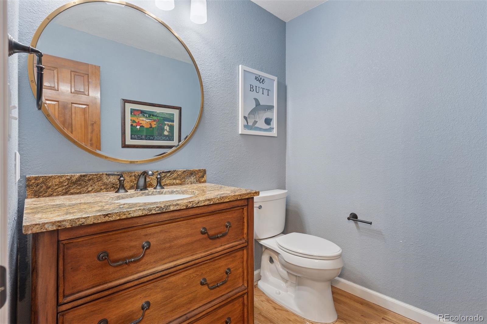 7501 Stroh Road Parker, CO 80134 - Photo 17 of 49 a bathroom with a granite countertop toilet sink and mirror