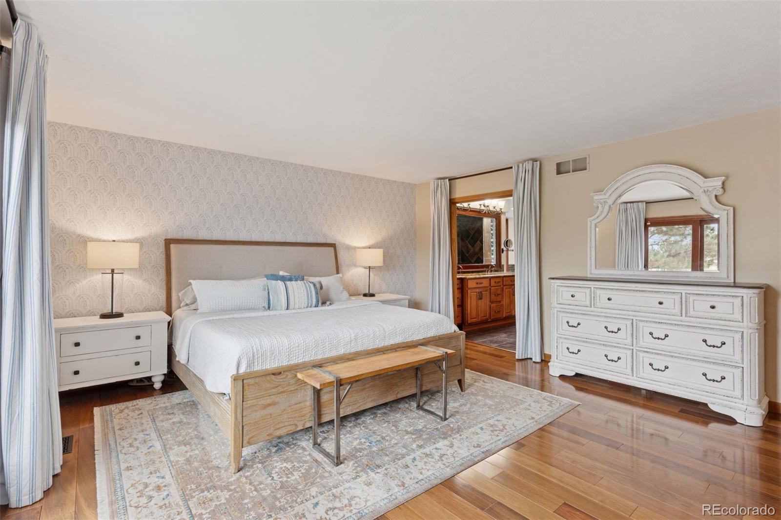 7501 Stroh Road Parker, CO 80134 - Photo 20 of 49 a bedroom with a bed and a dresser