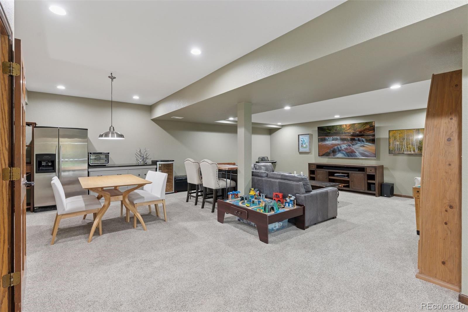 7501 Stroh Road Parker, CO 80134 - Photo 32 of 49 a living room with furniture and kitchen view
