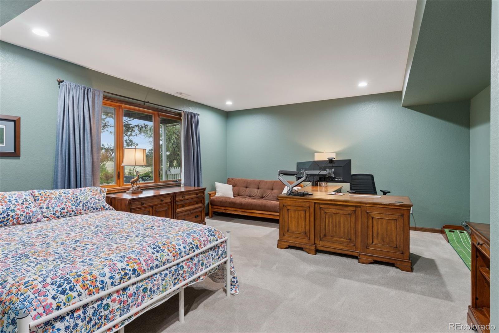 7501 Stroh Road Parker, CO 80134 - Photo 35 of 49 a bedroom with a bed and large windows