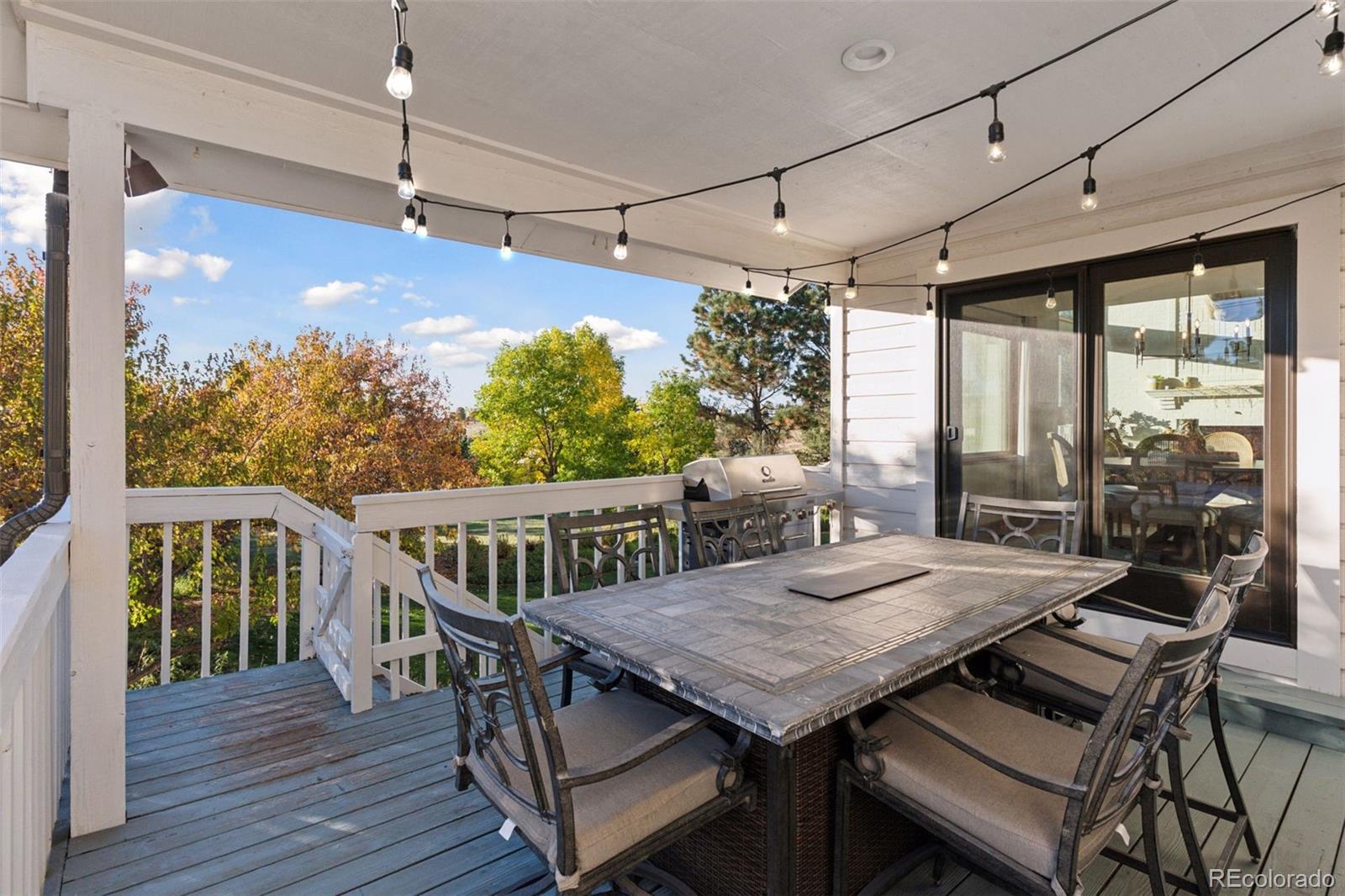 7501 Stroh Road Parker, CO 80134 - Photo 40 of 49 a view of a dining room with furniture window and wooden floor
