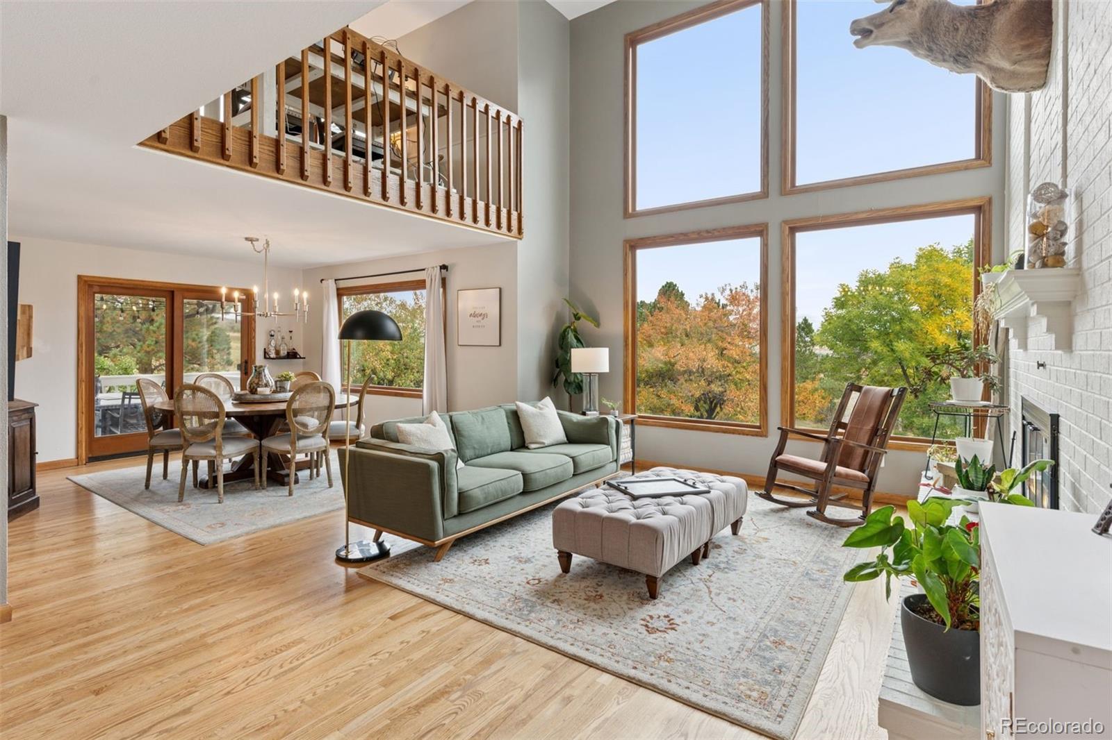 7501 Stroh Road Parker, CO 80134 - Photo 4 of 49 a living room with furniture and floor to ceiling windows