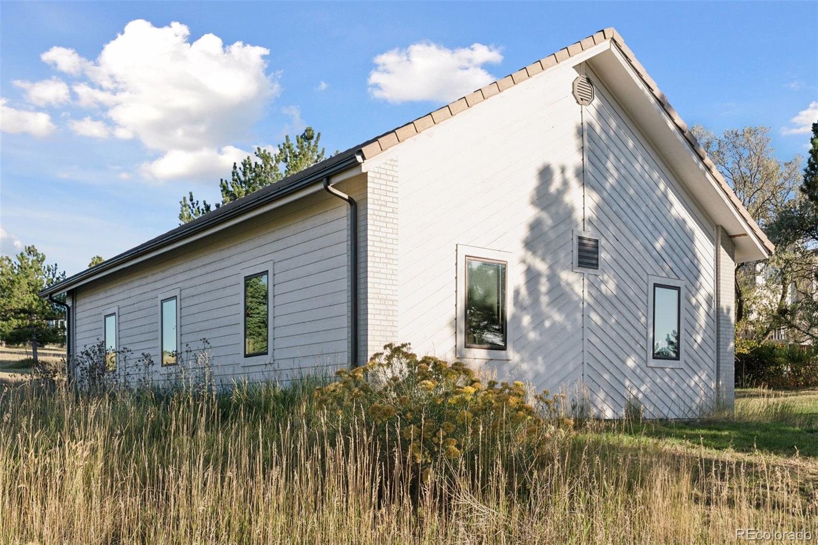 7501 Stroh Road Parker, CO 80134 - Photo 42 of 49 a backyard of a house with a garden and barbeque oven