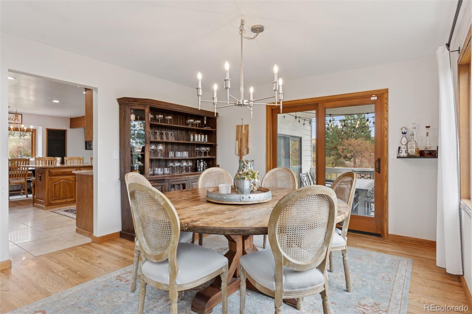 7501 Stroh Road Parker, CO 80134 - Photo 6 of 49 a view of a dining room with furniture window and wooden floor