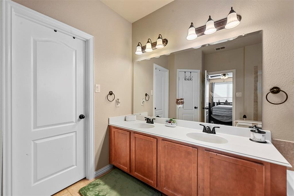 14815 Frisco Ranch Drive Little Elm, TX 75068 - Photo 17 of 40 a bathroom with a double vanity sink mirror and