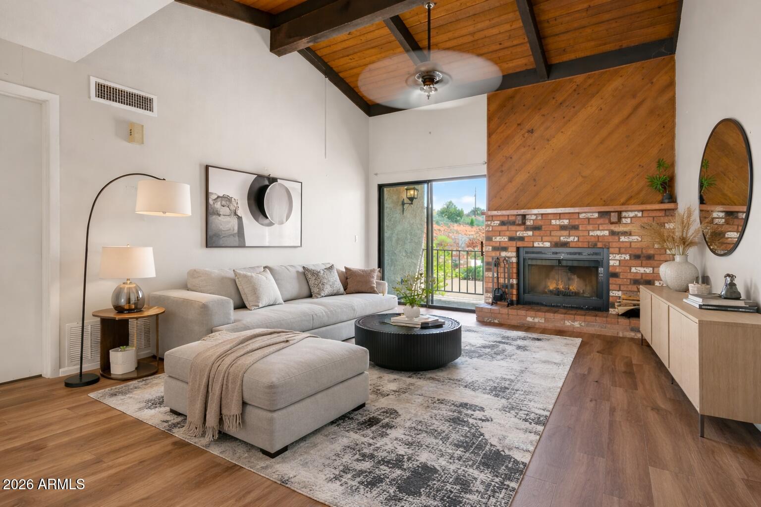 65 Verde Valley School Road, Unit D15 Sedona, AZ 86351 - Photo 11 of 27 a living room with furniture a fireplace and a flat screen tv